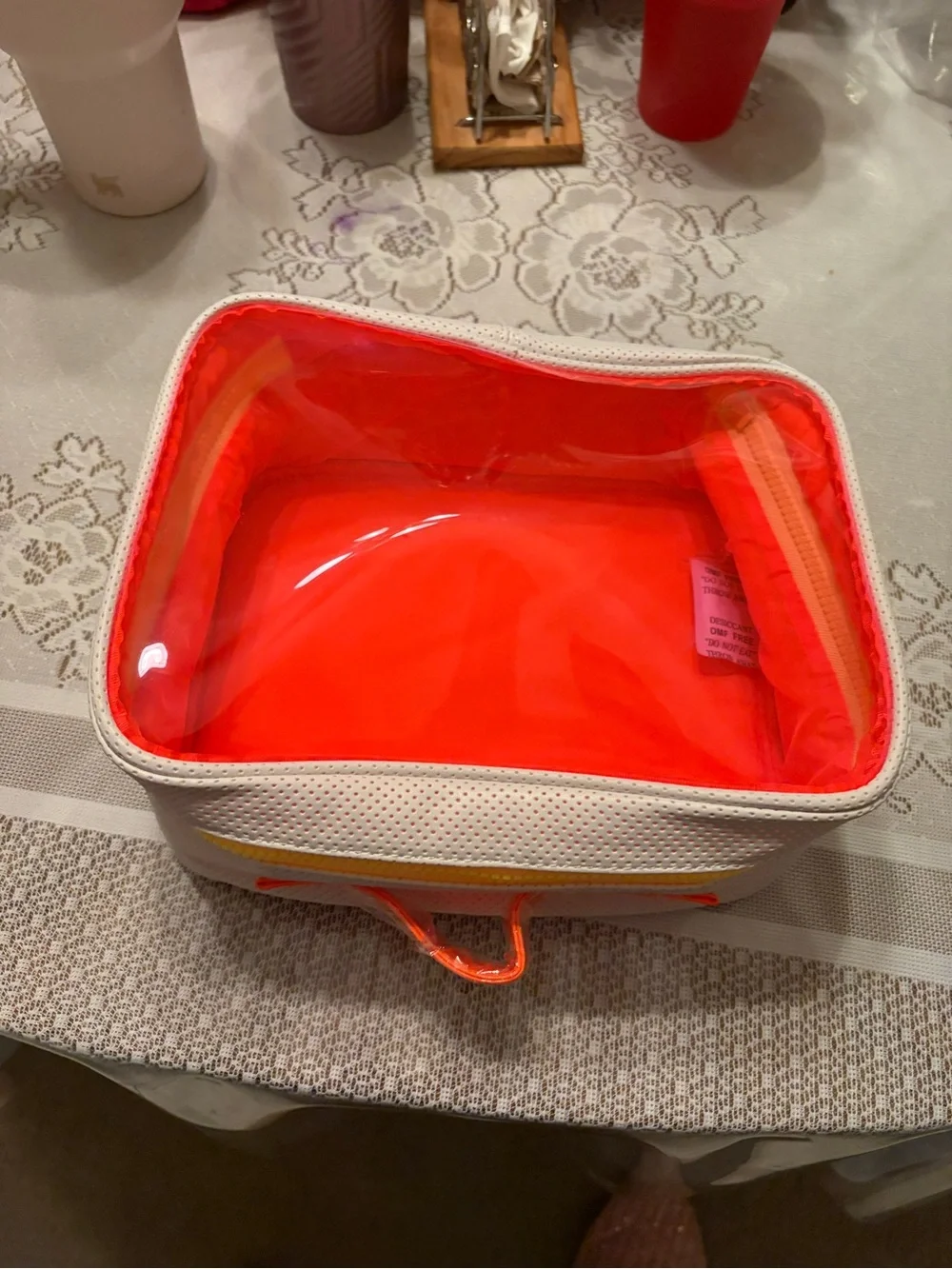 Drunk Elephant white and neon orange bag.
